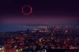 City skyline at night with a visible solar eclipse highlighting technology impact during natural events