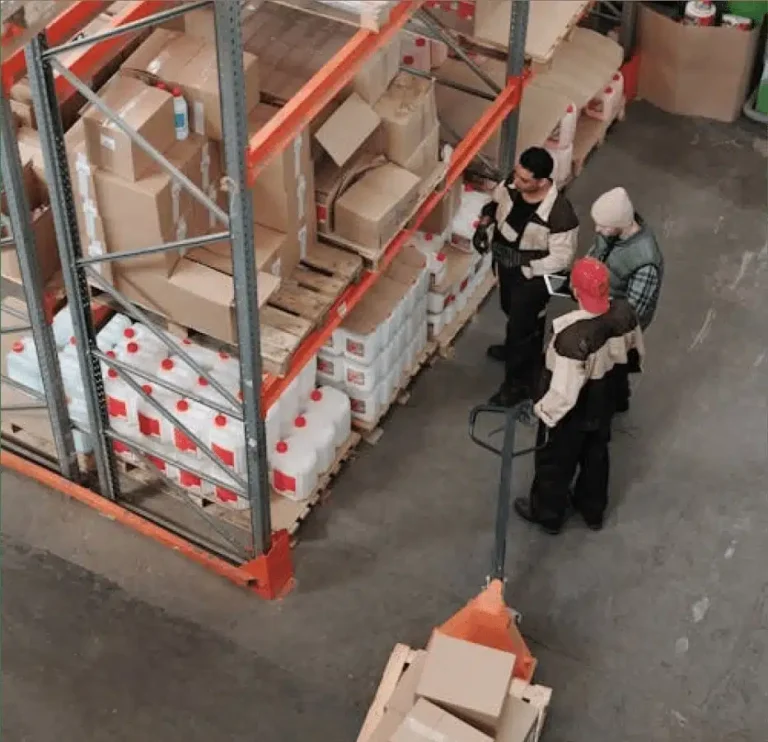 Insurance adjusters assessing damaged inventory in warehouse setting