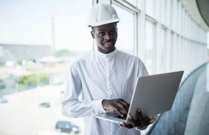 Technician in safety gear coordinating restoration services from a remote location